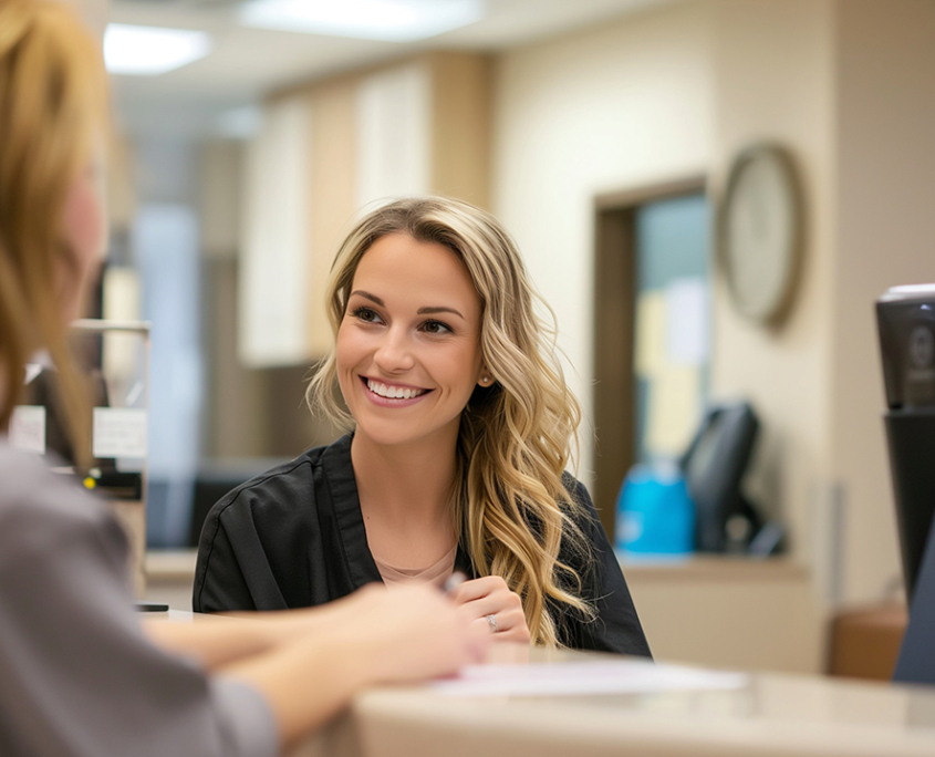 Reception desk area, emphasizing its cleanliness and professionalism, Smiling receptionist greeting patients